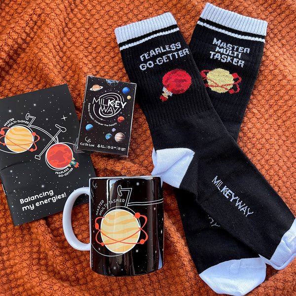 Venus & Mars Set - 1 Game, 1 Pair of Socks (Men Size), 1 Mug, 1 Notebook